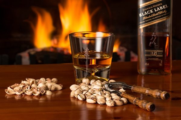 whiskey in glass with cigar and background